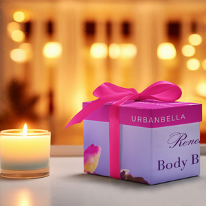 Urbanbella Mystery Box wrapped in elegant packaging with a pink ribbon, placed beside a glowing candle in a cozy evening setting.